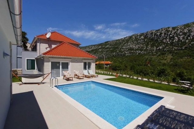 Sunlit Villa Zupa with private swimming pool and sunbeds in the valley of the mountain Biokovo