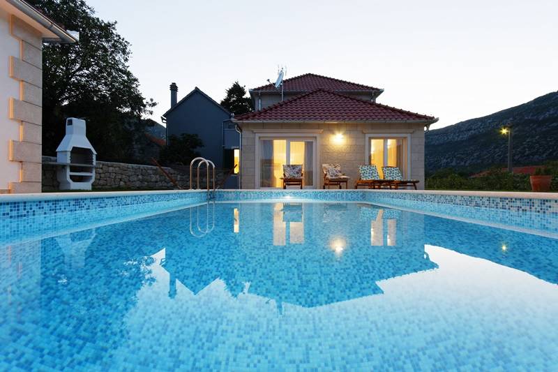 The swimming pool view on the Villa Zupa at the dusk